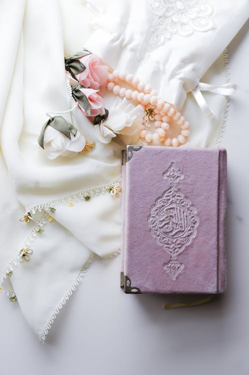 Pink Koran Book on a White Table