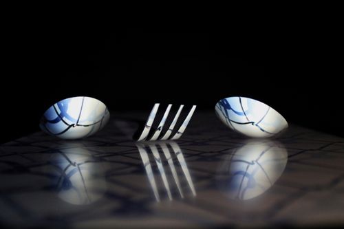 Free Abstract art of fork and bowls with reflections on a black background. Stock Photo
