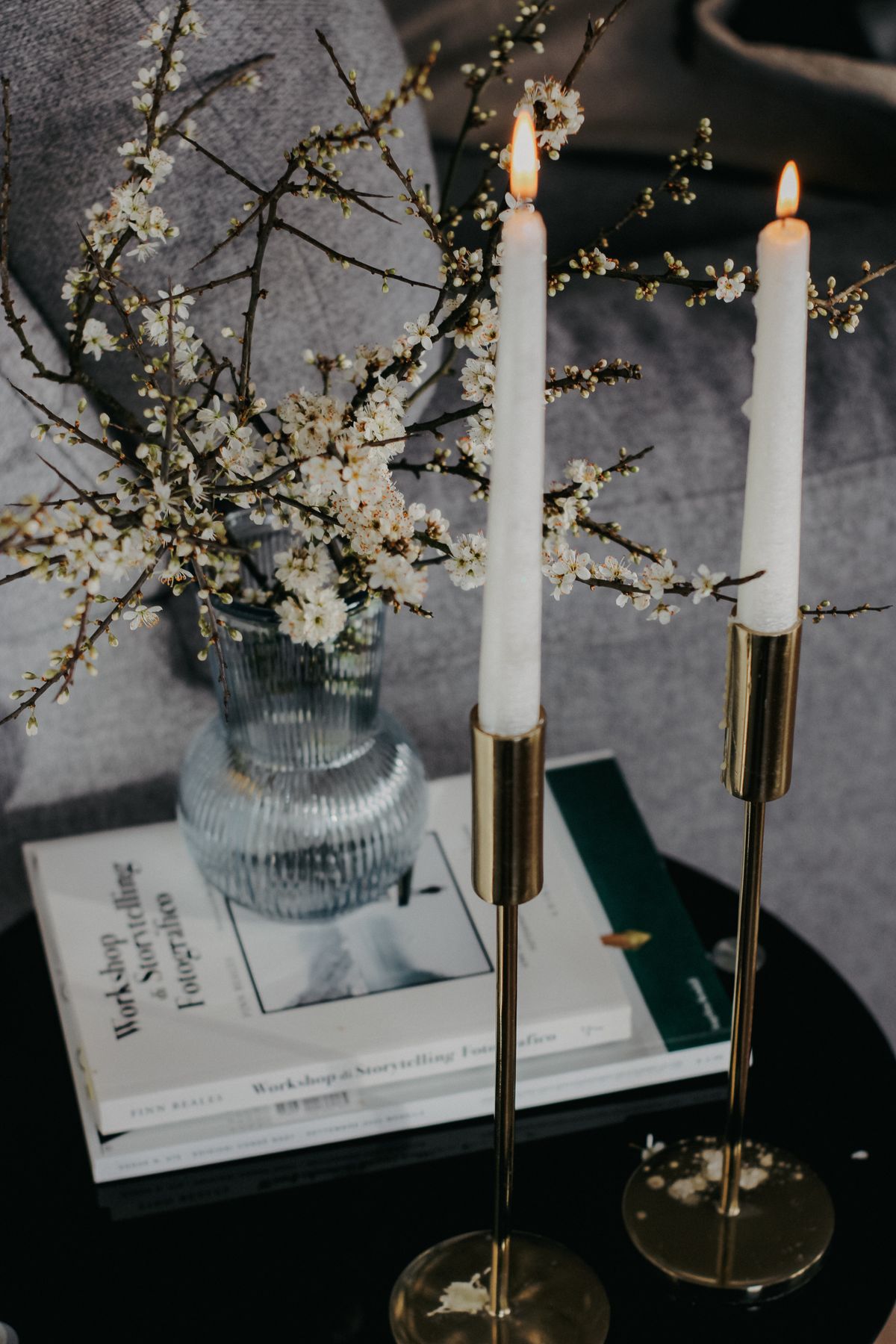 Branches in a vase with candles on a coffee table centrepiece