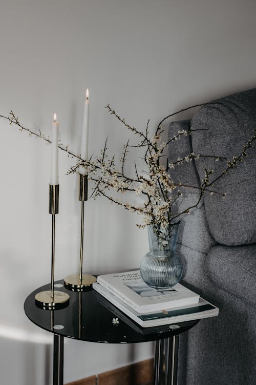 A black and white table with two candles and a vase