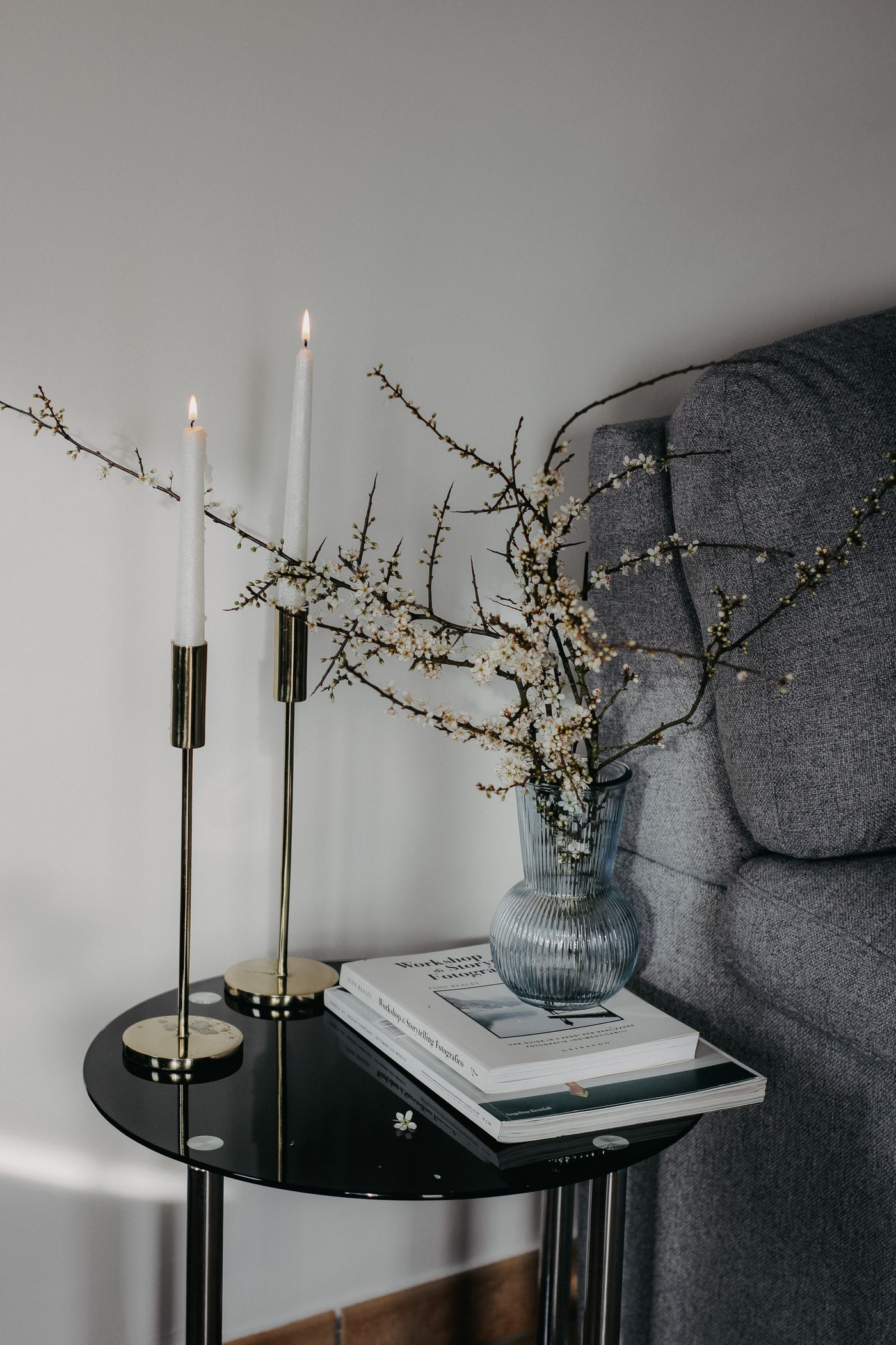Coffee-table arrangement with books, candles, and a vase