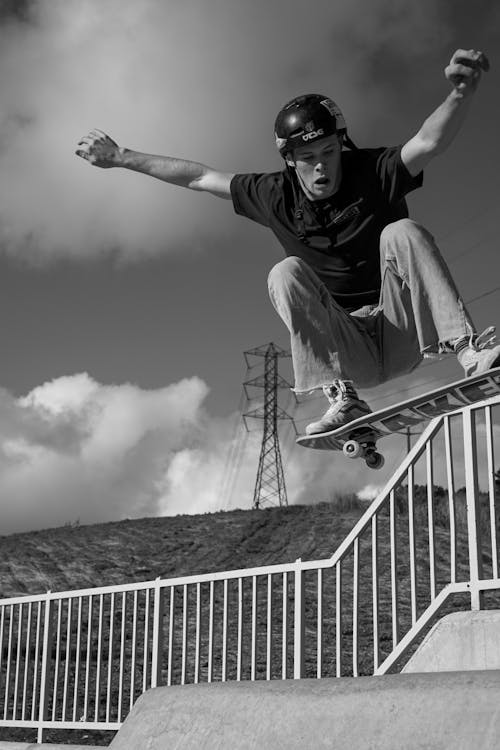 A black and white photo of a skateboarder doing a trick