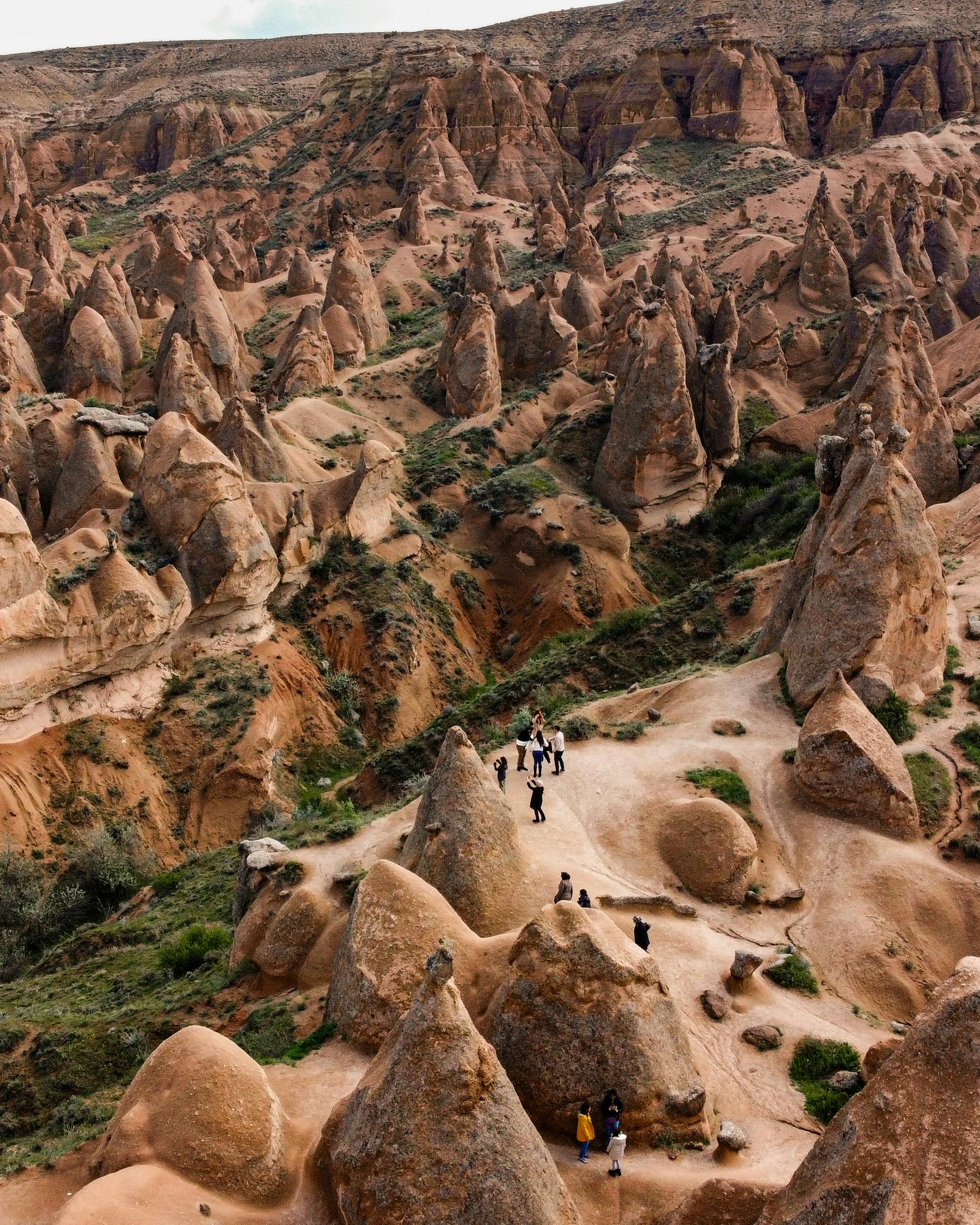 Stunning aerial photograph of Cappadocia's iconic rock formations, capturing natural beauty and travel intrigue.