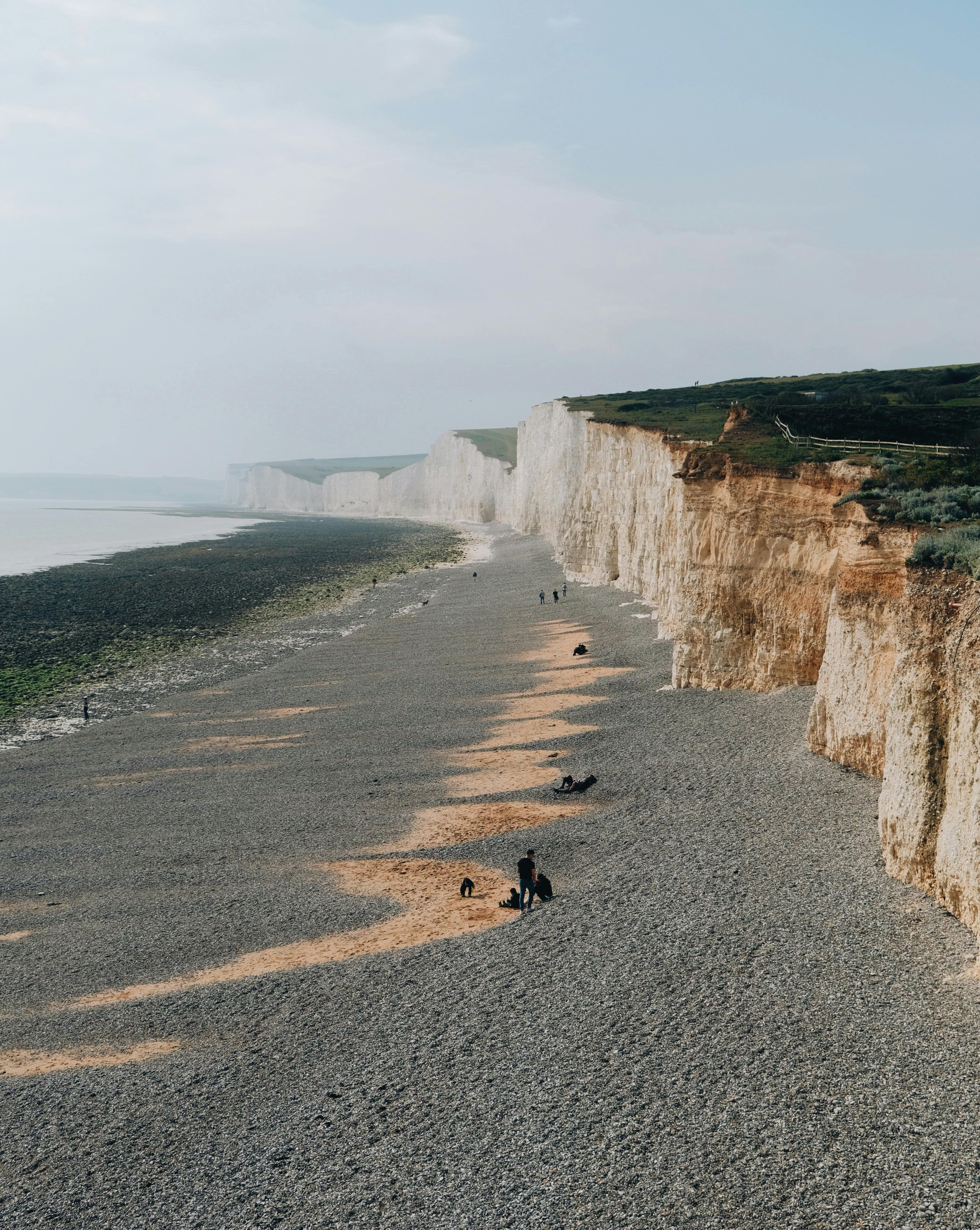 Explore the stunning white cliffs and pebbled beach of Seven Sisters, a natural wonder in England.