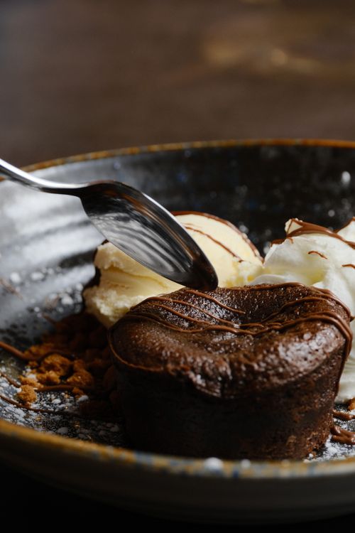 Free Indulgent chocolate lava cake with vanilla ice cream on a stylish plate. Stock Photo