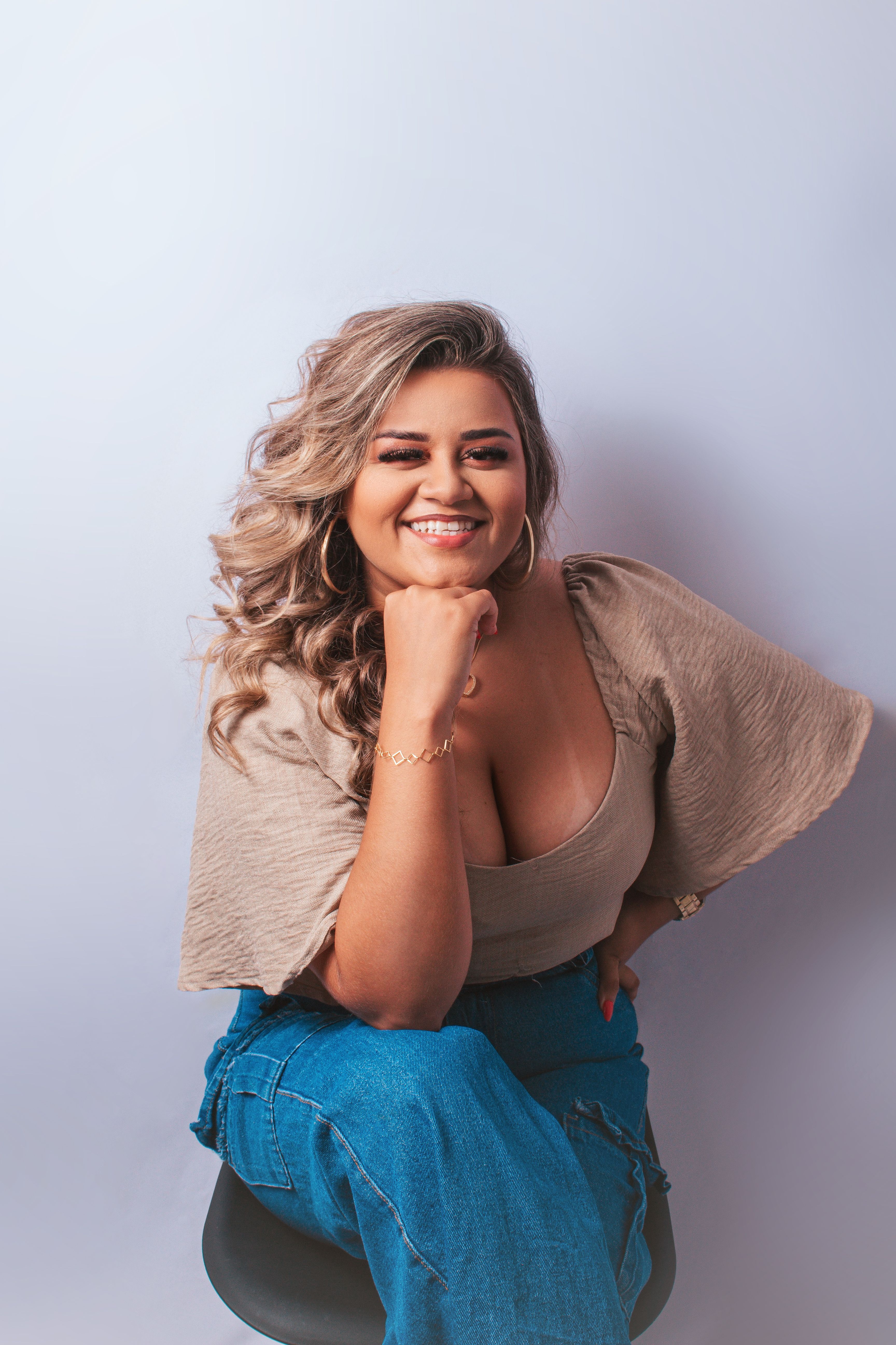 Portrait of a smiling woman in casual fashion, exuding confidence.