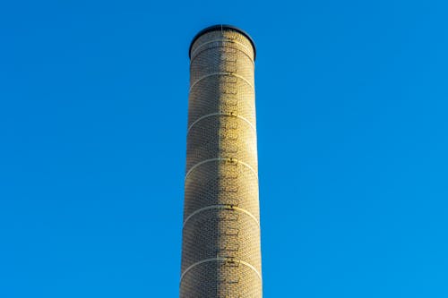 A tall chimney with a blue sky in the background