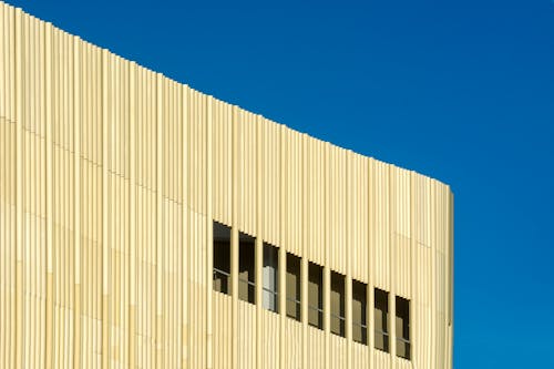 A building with a yellow facade and blue sky