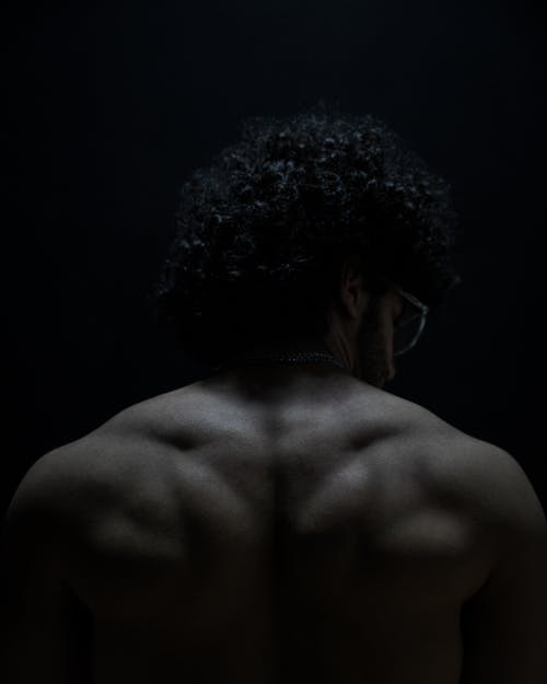 Black and White Back View Photo of a Muscular Man 