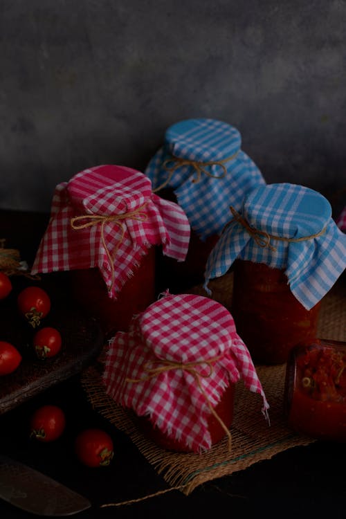 Free A table with jars of tomato sauce and a cloth Stock Photo