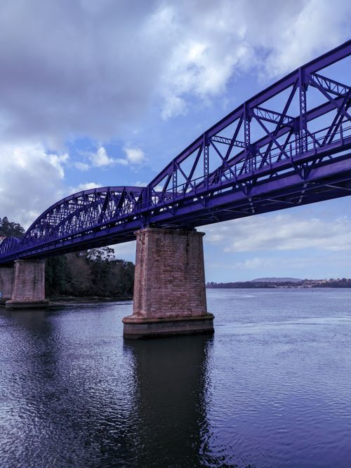 Free Beautiful vertical shot of the iconic Puente de Hierro bridge over the sea in Pontedeume, Spain. Stock Photo