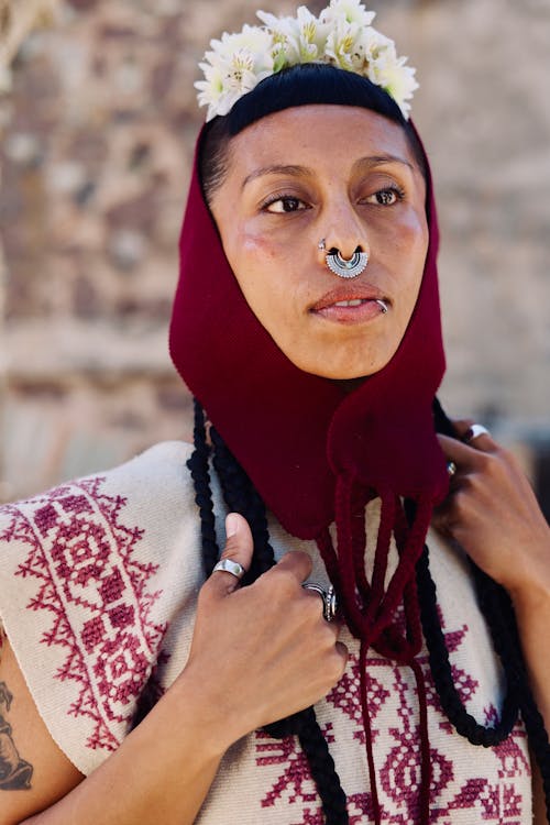 A woman with a nose ring and a red headdress