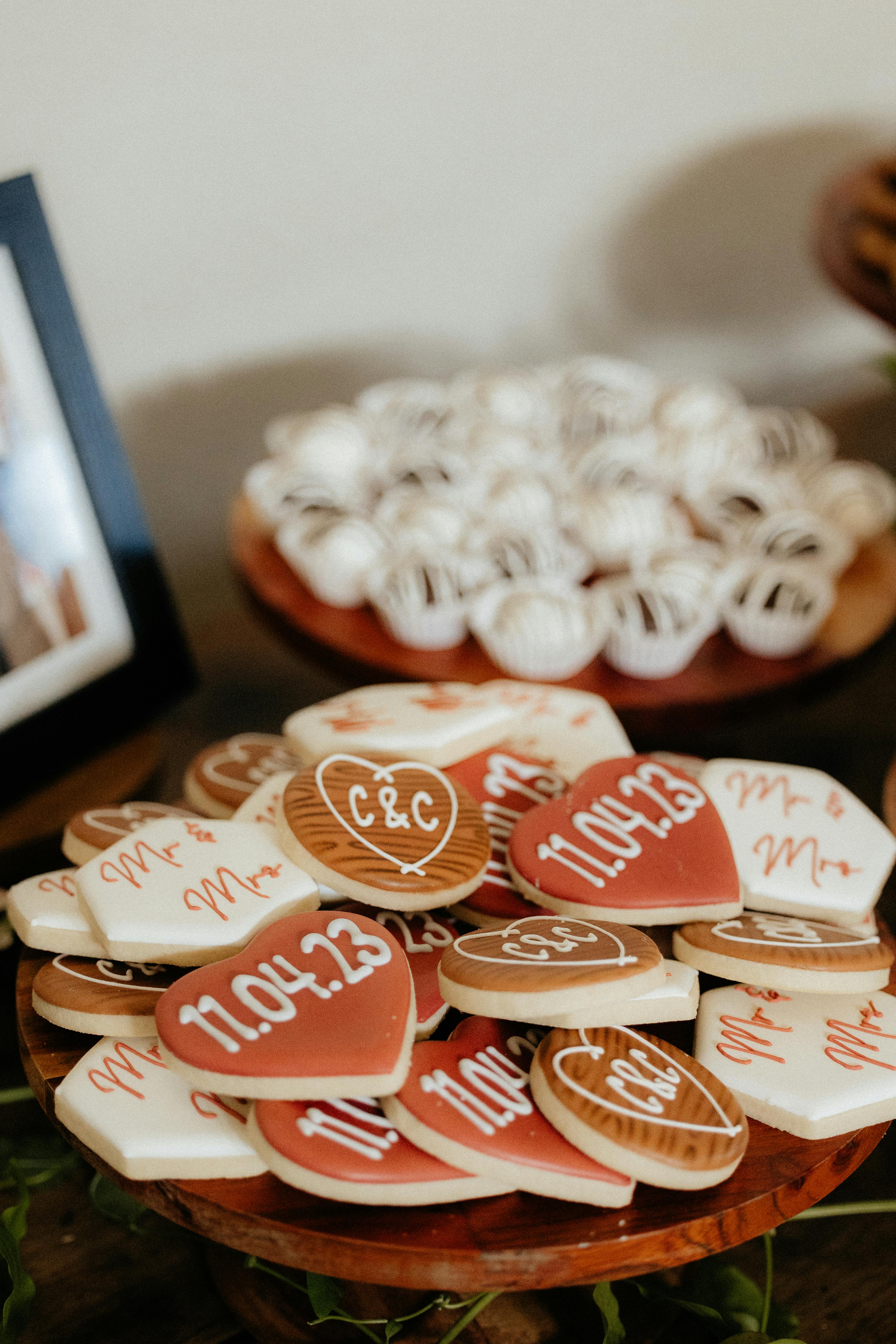 Close-up of decorative wedding cookies with names and dates, perfect for celebrations.