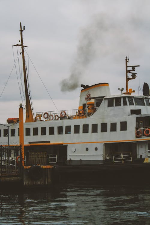 A ferry boat with smoke coming out of it