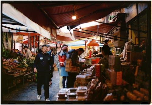 A photo of people walking through an outdoor market