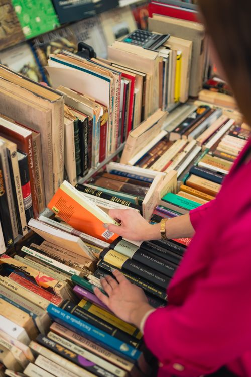 Free A person selecting books in an atmospheric Mexico City bookstore. Stock Photo