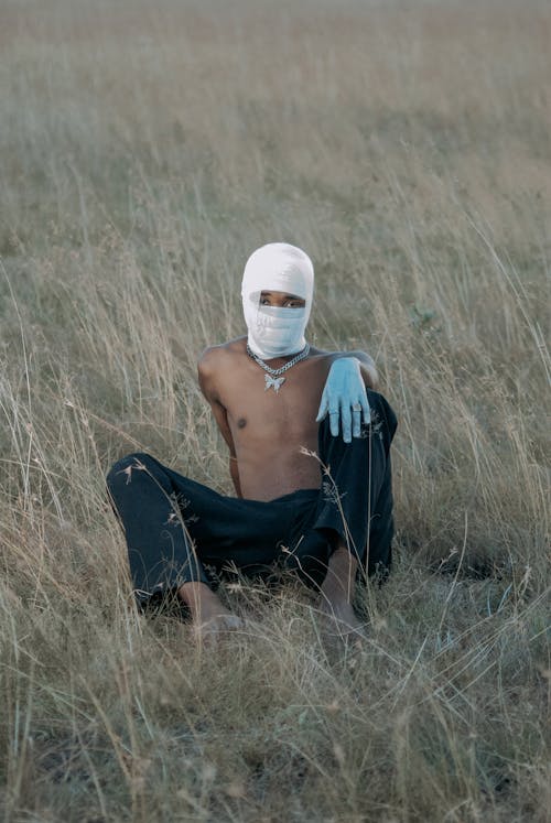 Topless Man in Balaclava on Field