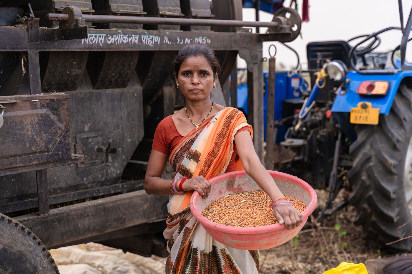 Indian farmer holding harvested grain
