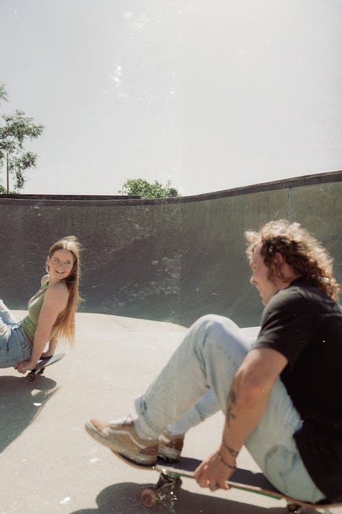 Boy and Girl Skateboarding in a Skatepark