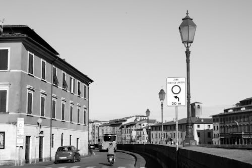 Black and White Photo of a Street along the River and Buildings in Pisa, Italy 