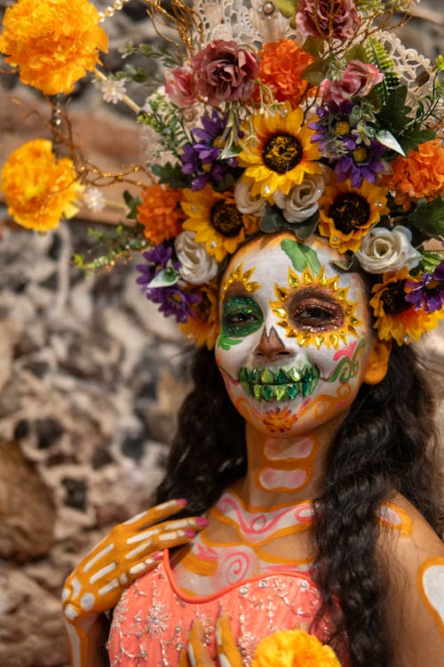 A woman with a flower headdress and face paint