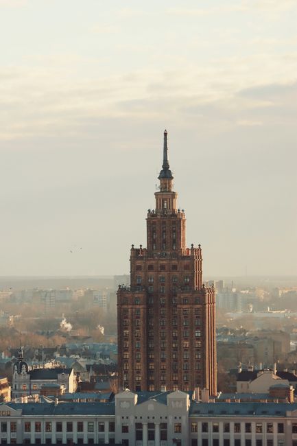Tall Soviet-era building in Riga, Latvia, showcasing unique architectural style at sunset.
