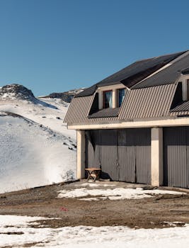 Scenic winter view of a chalet in Mavrovo, North Macedonia, under clear blue skies.