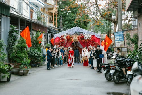 A wedding ceremony in a street with people walking