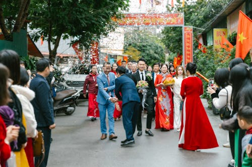 A wedding party in a street with people walking