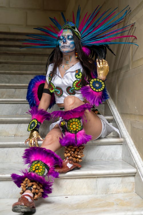 A woman dressed in a costume sitting on stairs