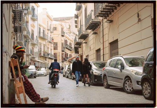 A man sitting on a bench in a narrow alley