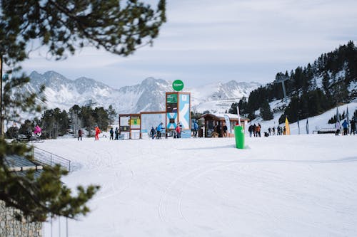 A ski slope with people on it and a mountain in the background