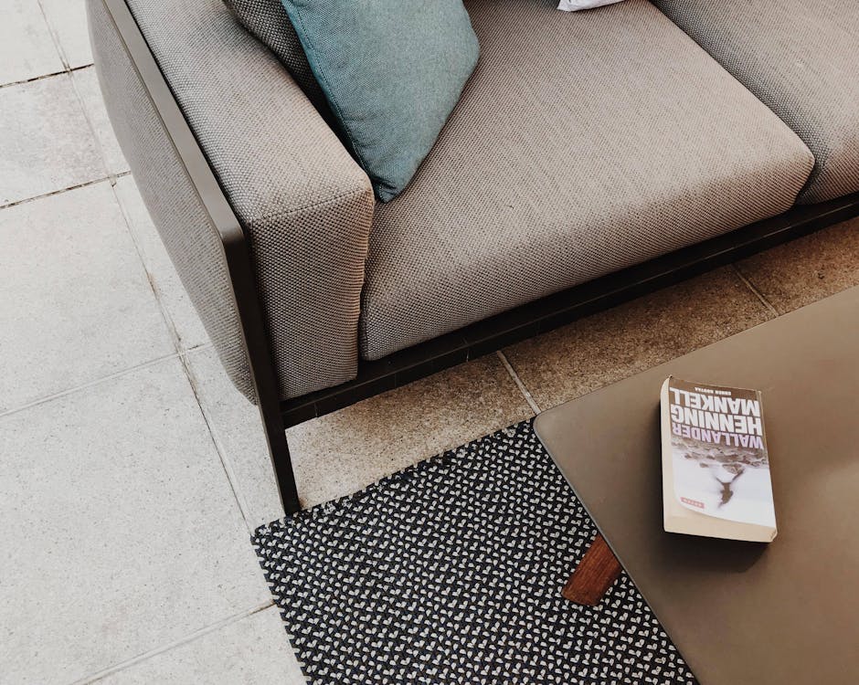 Free White and Brown Book on Table Near Couch Stock Photo