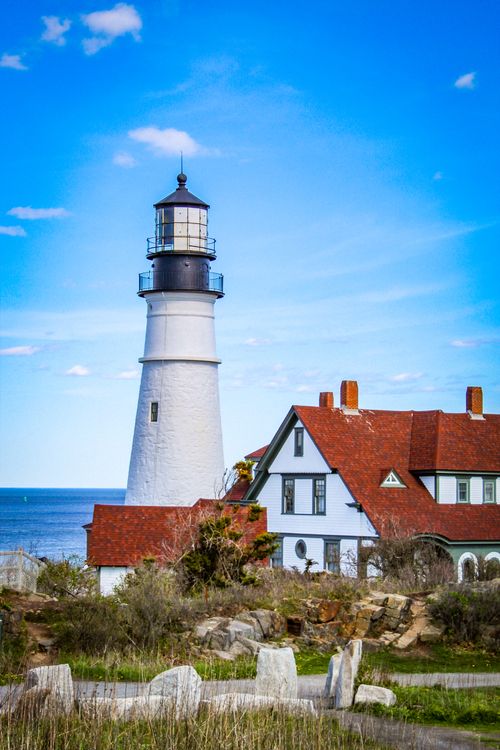 Free Scenic view of Portland Head Light Lighthouse against a vibrant blue sky. Stock Photo