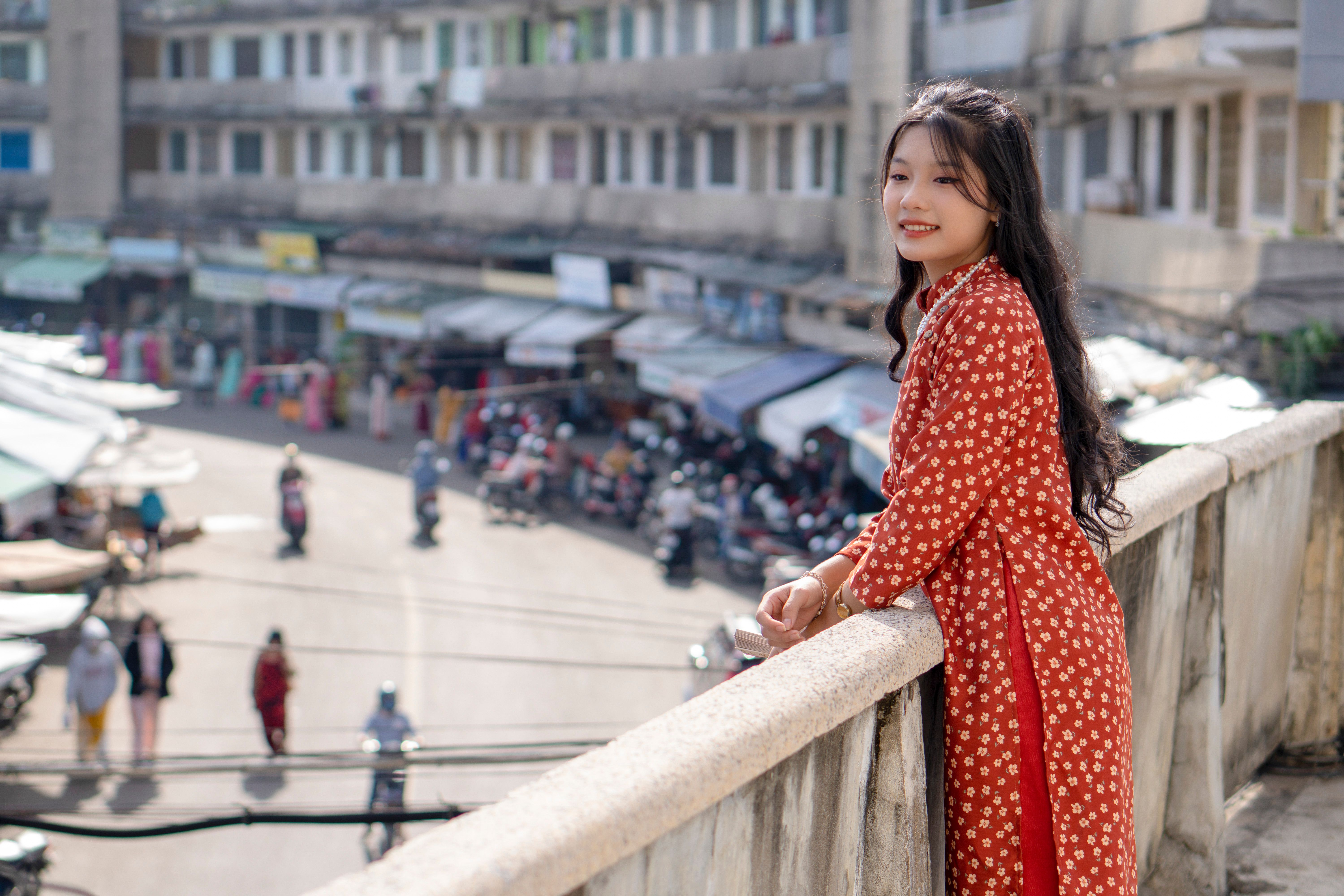 Young Woman in Traditional Clothing Posing on a Bridge · Free Stock Photo