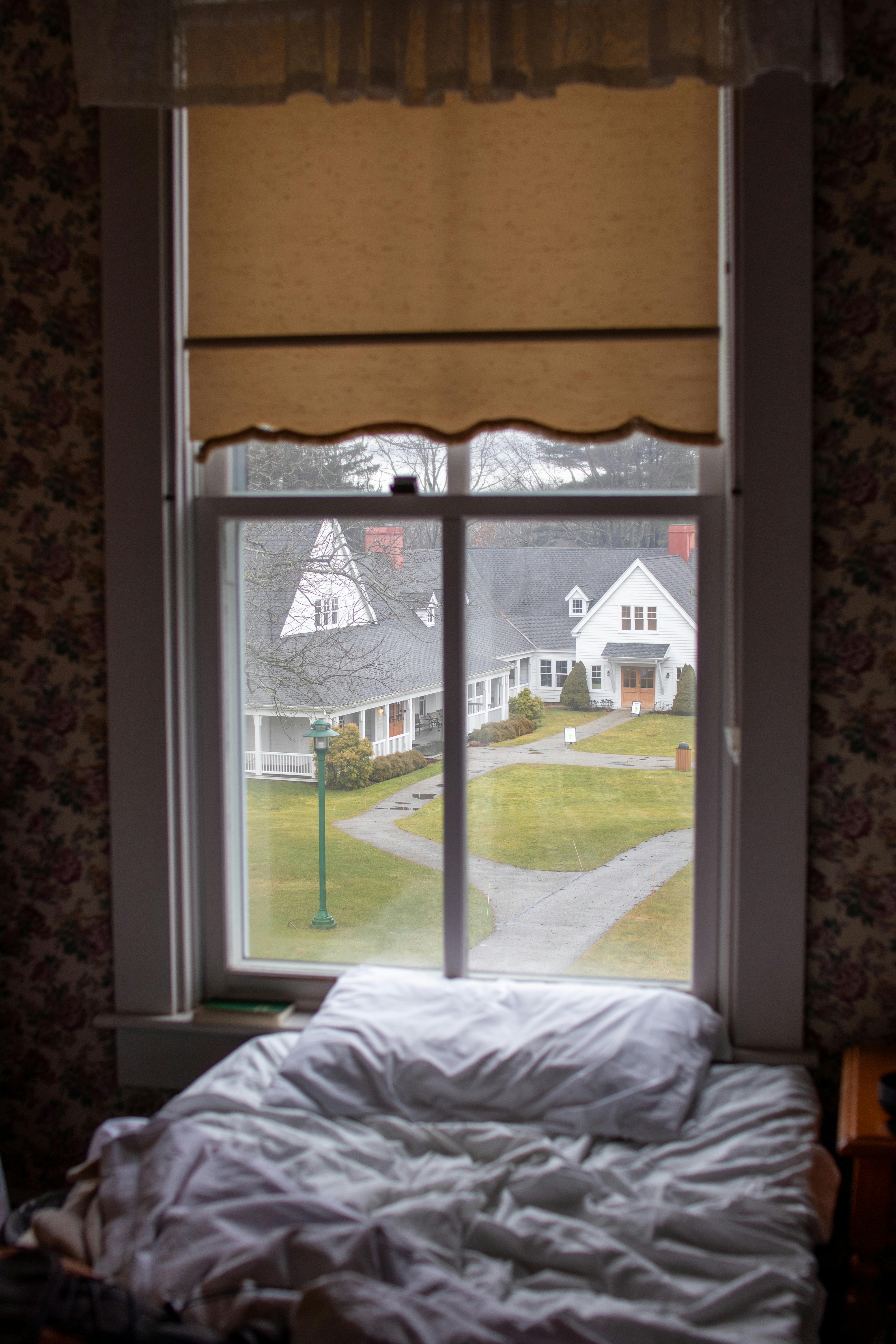 pillow on bed near windows