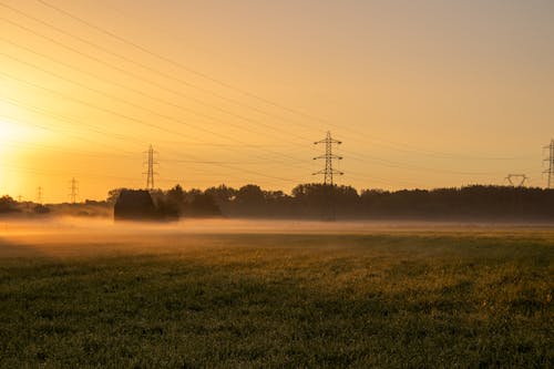 Free A farm with a misty sunrise in the background Stock Photo