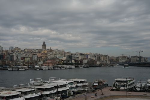 Free View of Istanbul's skyline with Galata Tower and Bosphorus Strait under overcast skies. Stock Photo