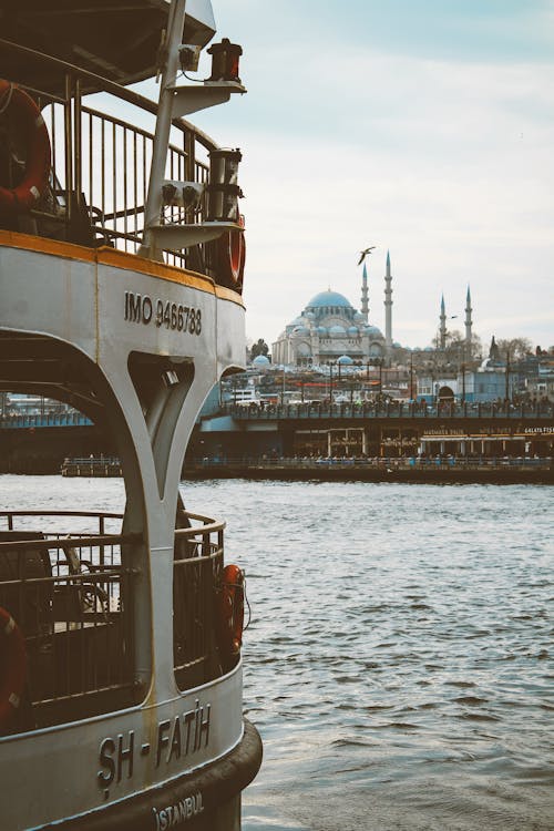 A boat with a view of a city and a mosque