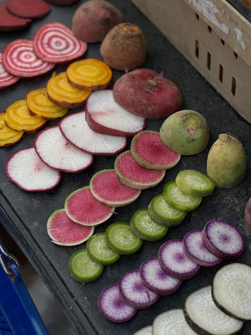 A display of sliced radishes and other vegetables