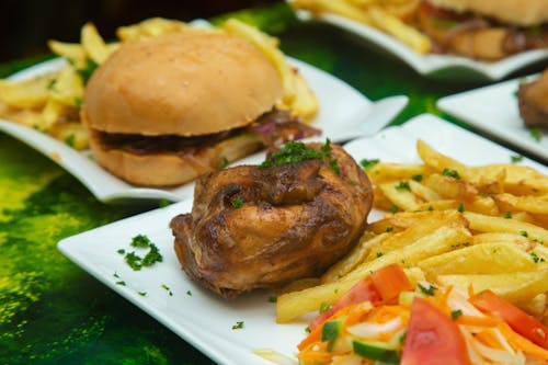 A plate of food with fries and chicken on it