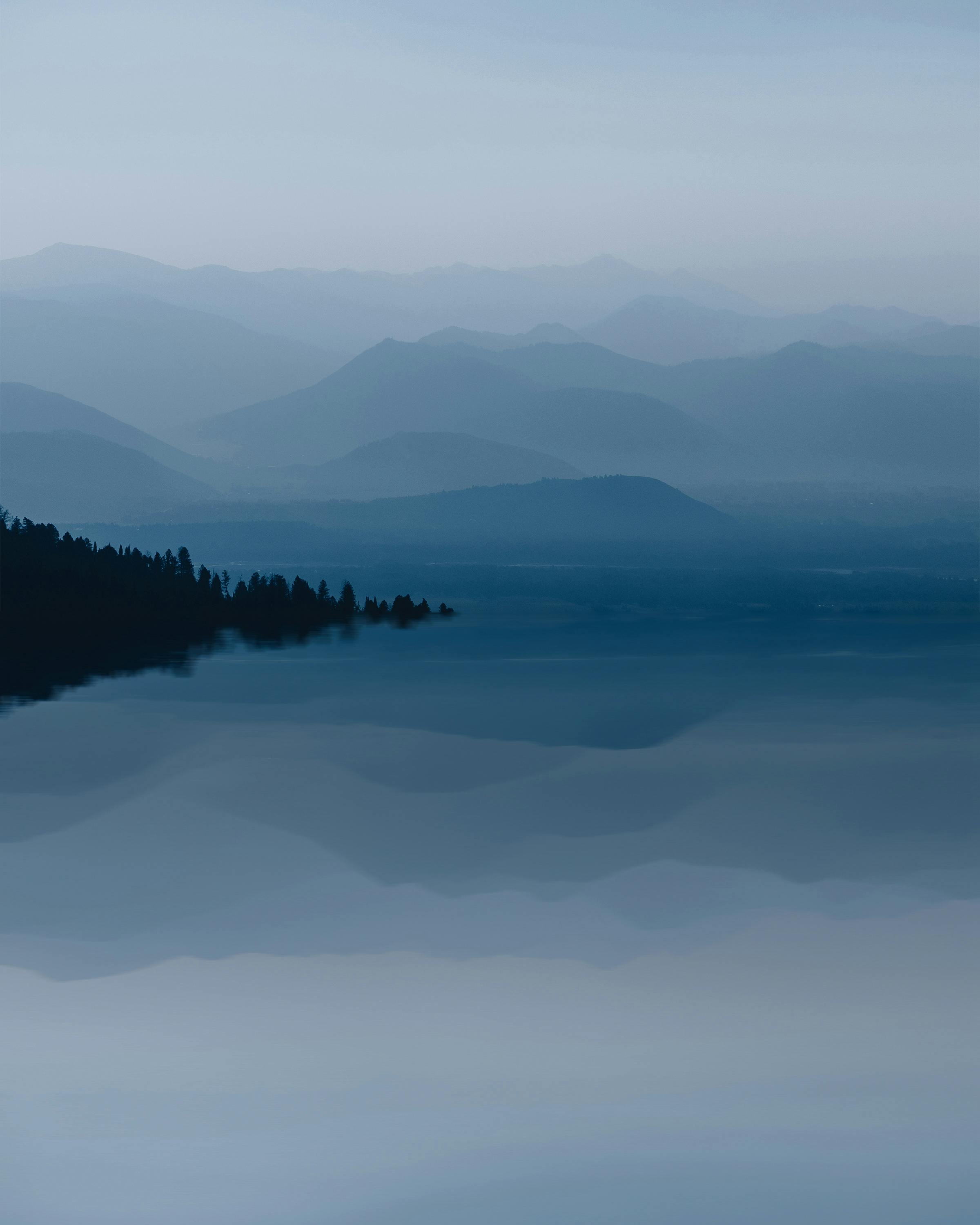 lake and mountains in wyoming usa on foggy day