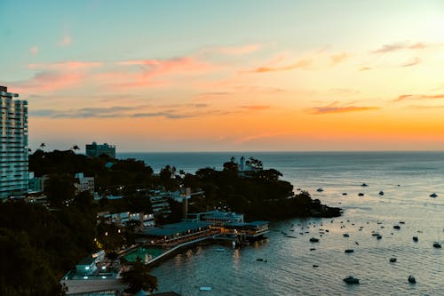 A sunset view of the ocean and boats