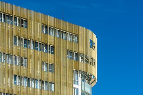 A building with a blue sky and gold metal