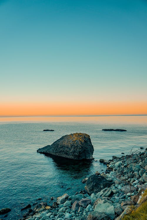Rocks on Sea Shore at Sunset