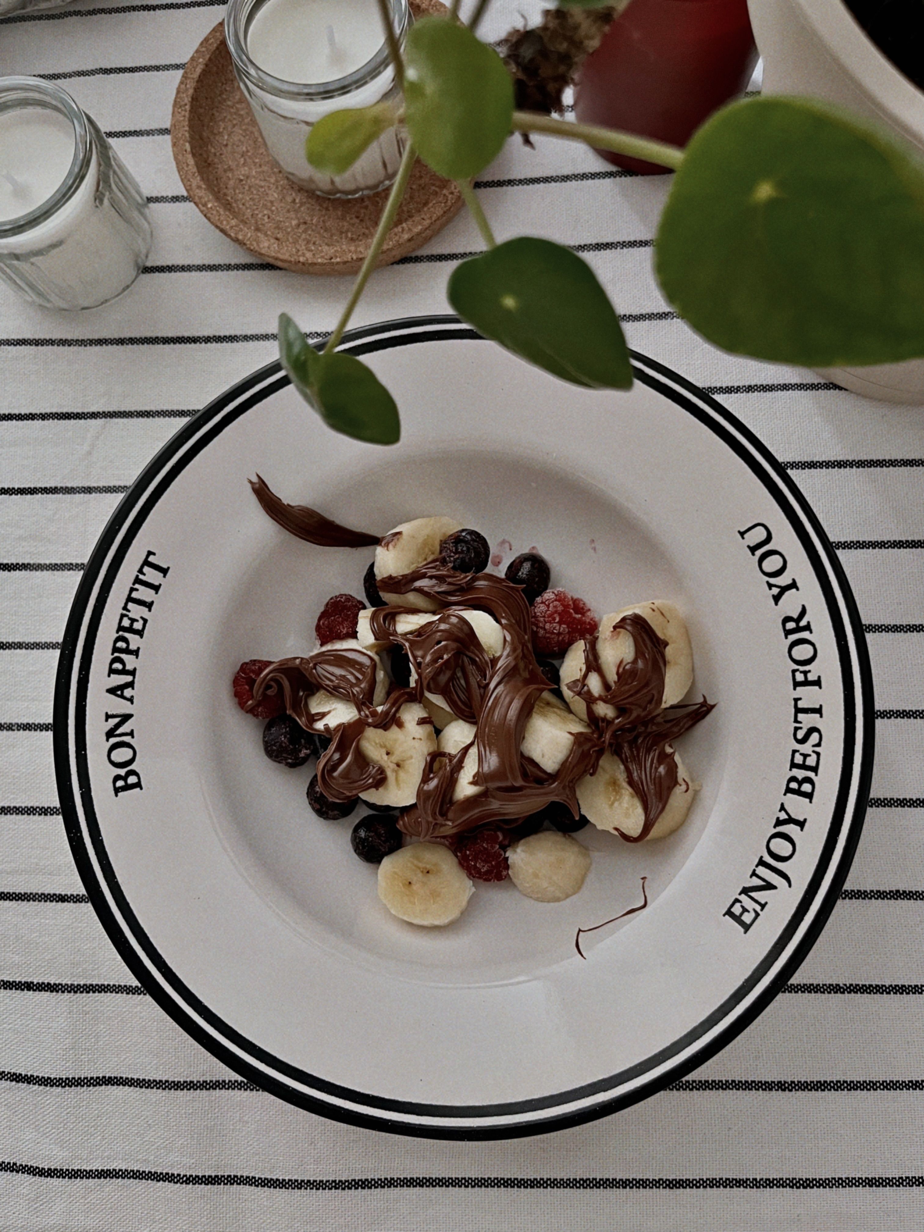 Top view of a delicious fruit plate with chocolate and bananas, perfect for dessert lovers.
