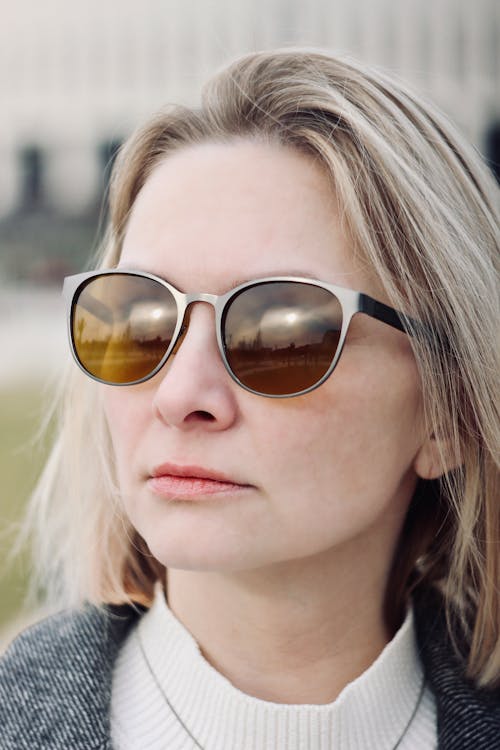 A woman with sunglasses on is looking at the camera