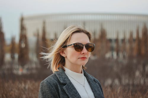 A woman wearing sunglasses in front of a building