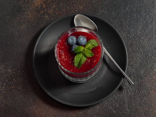 A dessert with berries and mint on a plate