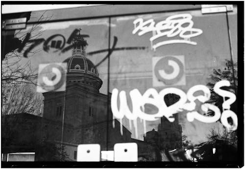 A black and white photo of graffiti on a building